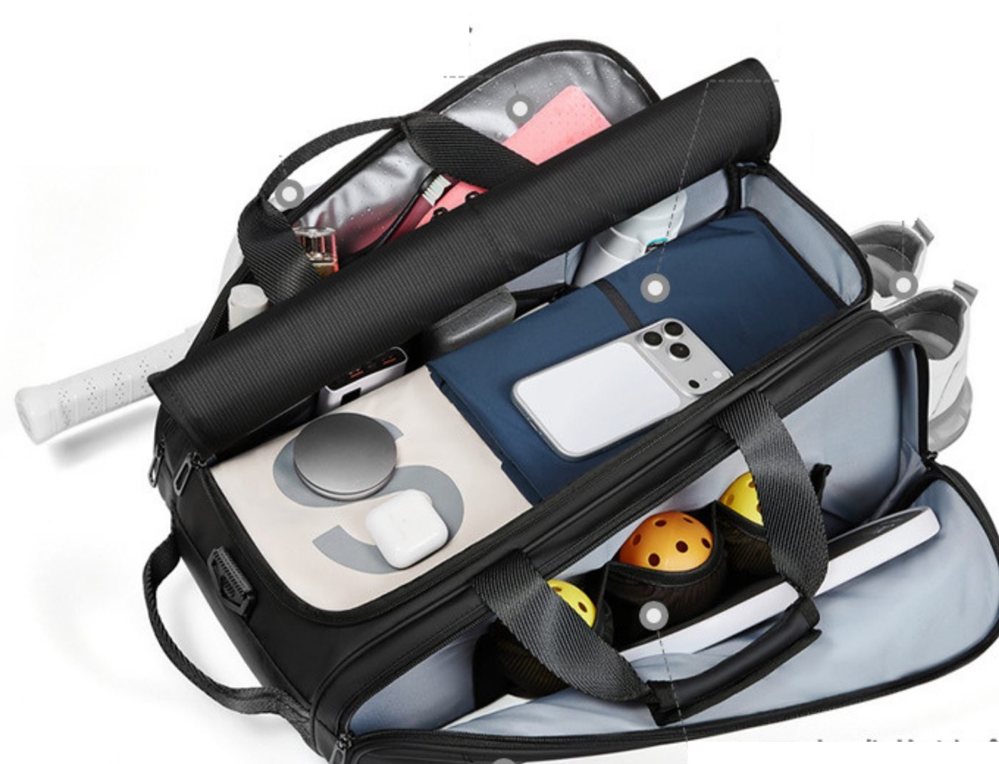 Bag opened to show compartments holding clothes, phone, balls, shoes and a paddle